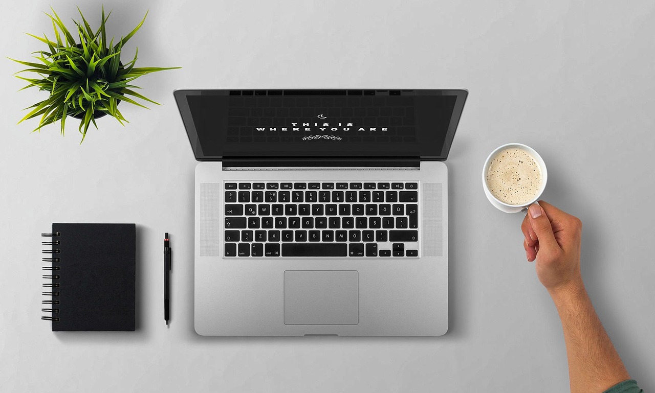 Laptop and notebook on a desk
